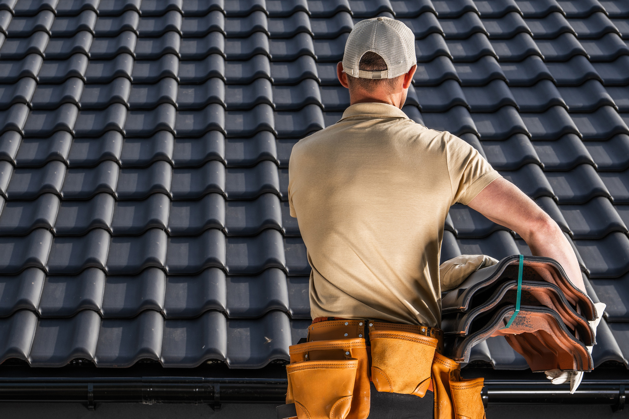 Roofer stood in front of newly tiled roof in portishead Roofer stood in front of newly tiled roof in portishead