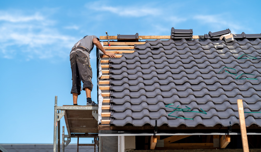 Roofer working on a new roof in Portishead Roofer working on a new roof in Portishead
